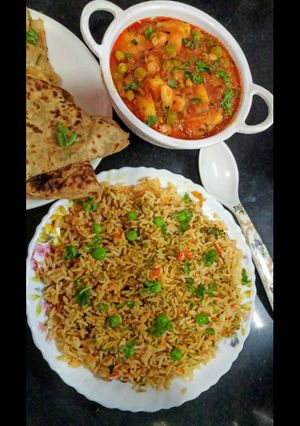A picture of Matar Aloo with Biryani Rice and paratha.