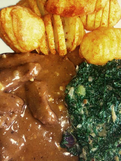 A picture of Beef in Beer Gravy and Hasselback potatoes.