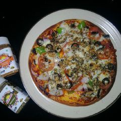 A picture of Veggie loaded cheese pizza.