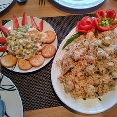 A picture of Chicken balls rice with Russian salad.
