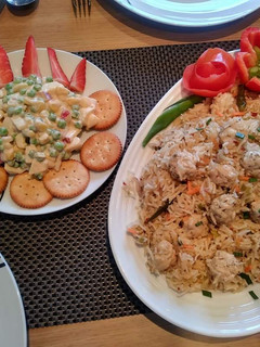 A picture of Chicken balls rice with Russian salad.