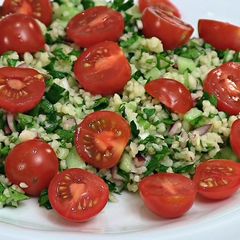 A picture of Tabouleh (Tabbouleh) salad with cherry tomatoes.