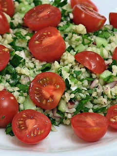A picture of Tabouleh (Tabbouleh) salad with cherry tomatoes.
