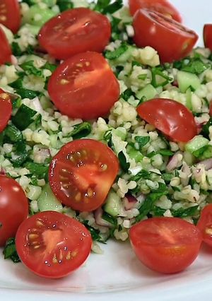 A picture of Tabouleh (Tabbouleh) salad with cherry tomatoes.