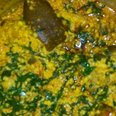 A picture of Egusi soup and goat meat.