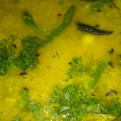 A picture of Red lentil with garlic and chopped coriander leaves.