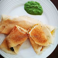 A picture of Masala Dosa with coriander coconut chutney.