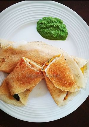 A picture of Masala Dosa with coriander coconut chutney.