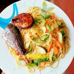 A picture of Vegetable pasta with fried fish.