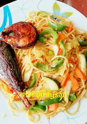 A picture of Vegetable pasta with fried fish.