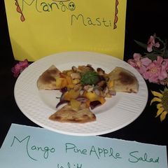 A picture of Mango pineapple salad with tortilla.