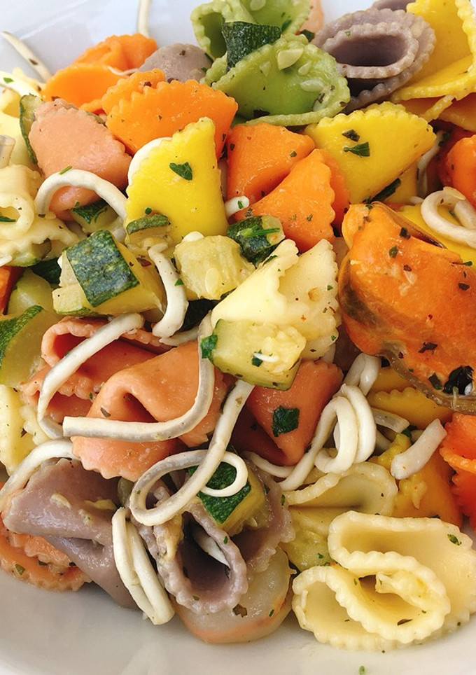 Una foto de Pasta de colores con mariscos y calabacín