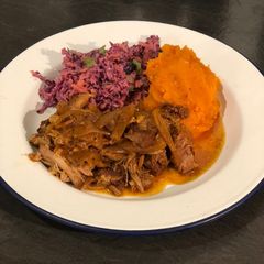 A picture of Slow cooked pulled pork with sweet potato mash and healthy slaw.