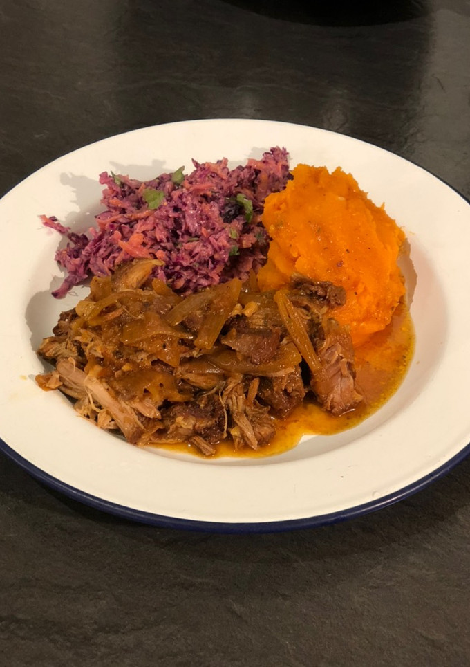 A picture of Slow cooked pulled pork with sweet potato mash and healthy slaw.
