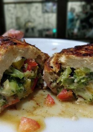 A picture of Broccoli and cheese wrapped in chicken breasts.
