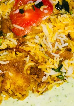 A picture of Alu chicken leg pc biryani.