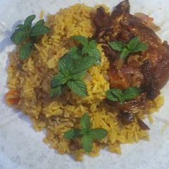 A picture of Fried rice with peppered chicken.