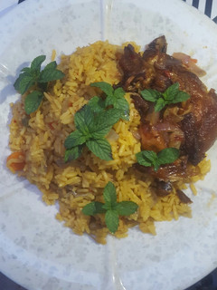 A picture of Fried rice with peppered chicken.