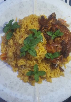 A picture of Fried rice with peppered chicken.