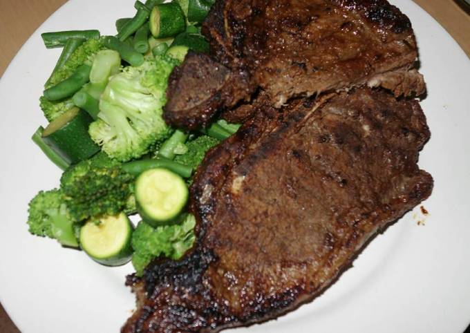 T bone steak with green vegetables