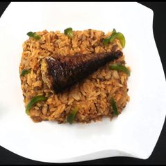 A picture of Beans and rice with smoked fish.