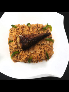 A picture of Beans and rice with smoked fish.