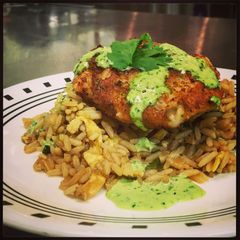 A picture of Crispy Rock Shrimp Cakes with a Cilantro Jalapeno Green Sauce.