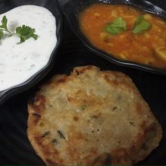 Vrat waale Aloo and Samak rice roti with dhania curd A picture of Vrat waale Aloo and Samak rice roti with dhania curd.