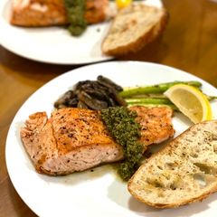 A picture of Grilled salmon with homemade pesto sauce.
