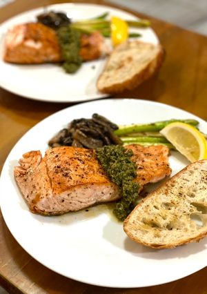 A picture of Grilled salmon with homemade pesto sauce.