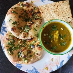 A picture of Lasooni Palak Paneer With Garlic Naan.