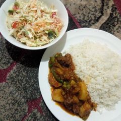 A picture of White rice with beef and potato soup and creamy salad.