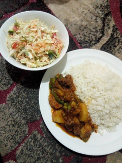 A picture of White rice with beef and potato soup and creamy salad.