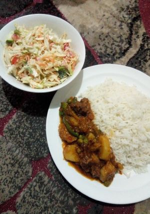 A picture of White rice with beef and potato soup and creamy salad.