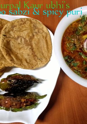A picture of 'Aloo sabzi & spicy puri' (potato curry & Indian fried bread).