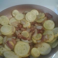 A picture of Summer squash with bacon.
