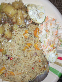 A picture of Vegetarian Jallof rice with potatoes and coleslaw.