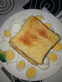 A picture of Butter Toasted Bread with Boiled Eggs.