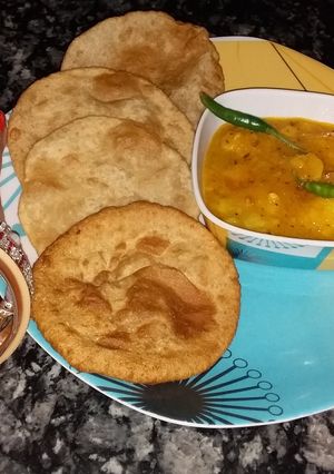 A picture of Potato veg with pooris.