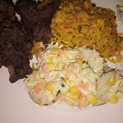 A picture of Chinese fried rice with coleslow and fry meat.