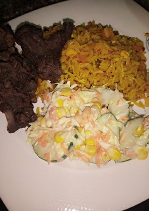 A picture of Chinese fried rice with coleslow and fry meat.