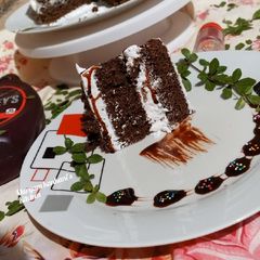 A picture of Chocolate cake with whip cream.