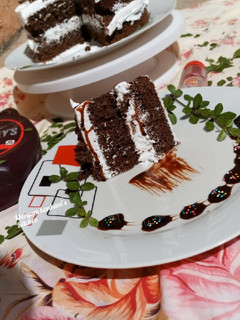 A picture of Chocolate cake with whip cream.