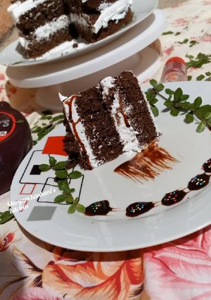 A picture of Chocolate cake with whip cream.