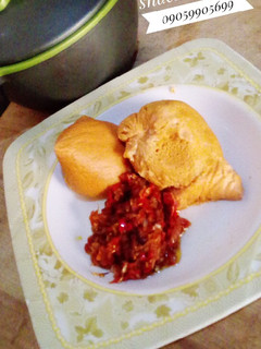 A picture of Moi moi and pepper sauce.