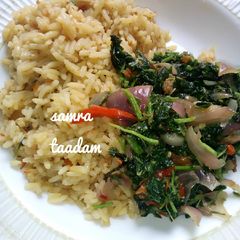 A picture of Jollofrice with spinach sauce.