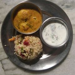 A picture of Aloo Dum Curry with Veg Pulav.