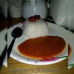 A picture of Rice with tomato soup.