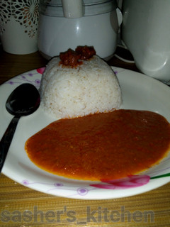 A picture of Rice with tomato soup.