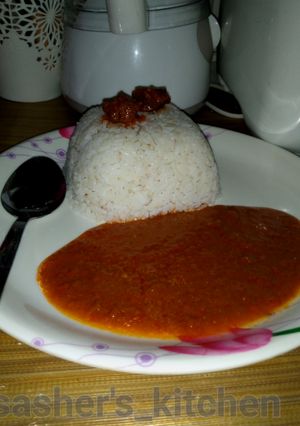 A picture of Rice with tomato soup.